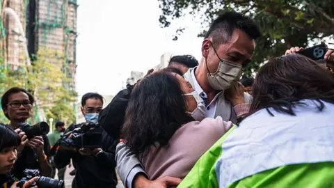 Tragedy in Hong Kong: Families Await News After Devastating High-Rise Fire