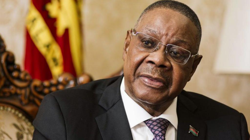 Peter Mutharika wearing a black suit and dotted tie speaks during an interview in Lilongwe, Malawi