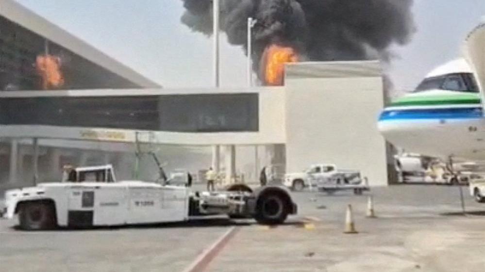 Smoke and flames rise from King Khalid Airport after a Houthi attack