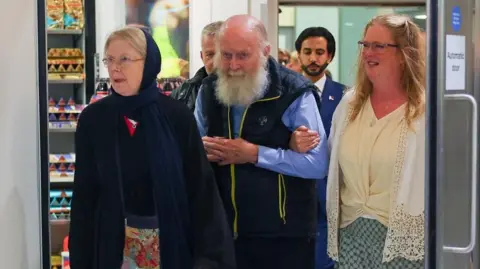 British Couple Freed from Taliban Detention Arrives Back in the UK