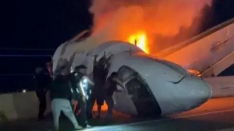 Bystanders rush to rescue aircraft passengers after fiery Texas crash